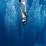 Adrenalin-Pumping Activities - Unrecognizable lady swimming underwater after jumping in ocean