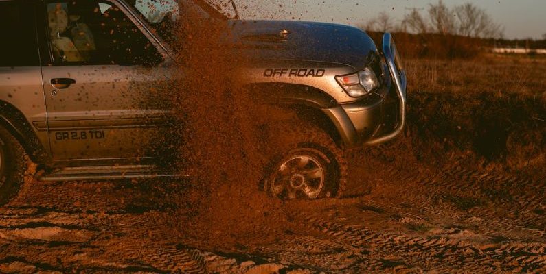 4WD Tracks - Photo Of a Man Driving 4x4 Off Road Car