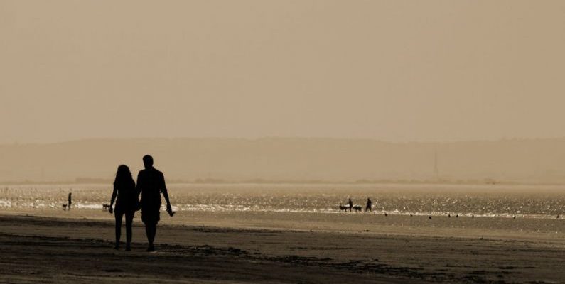 Coastal Walks - Silhouette Man and Woman Walking Near Sea