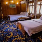 Luxury Hostels - Two Double Beds in the Room with Blue Carpet and Wooden Walls