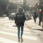 Backpacker-Friendly Cities - A woman walking across a street in a city
