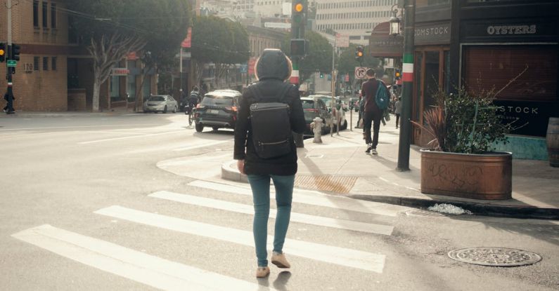 Backpacker-Friendly Cities - A woman walking across a street in a city