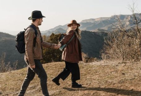 Experienced Backpackers - Couple Walking Holding Hands