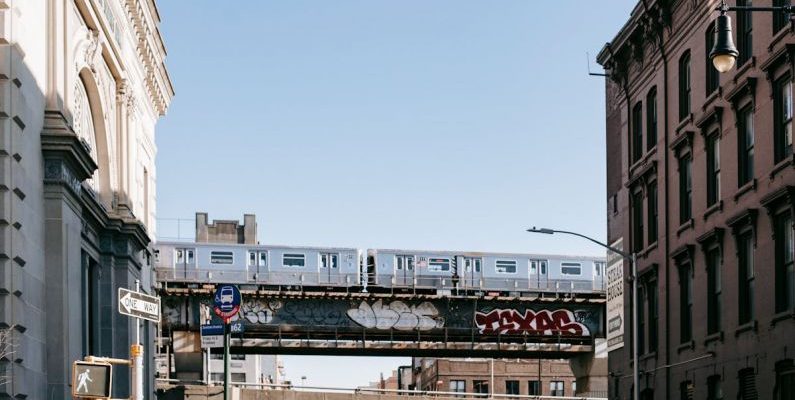 Scenic Train Rides - Train driving on railroad on bridge over street