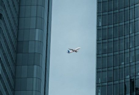 Fly Between Cities - Airplane Flying Between Skyscrapers