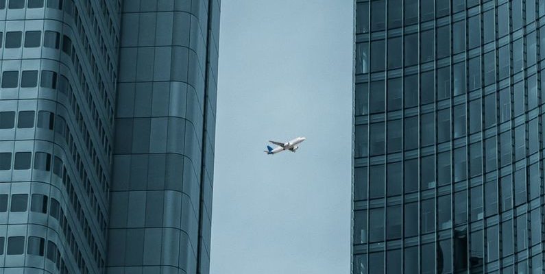 Fly Between Cities - Airplane Flying Between Skyscrapers